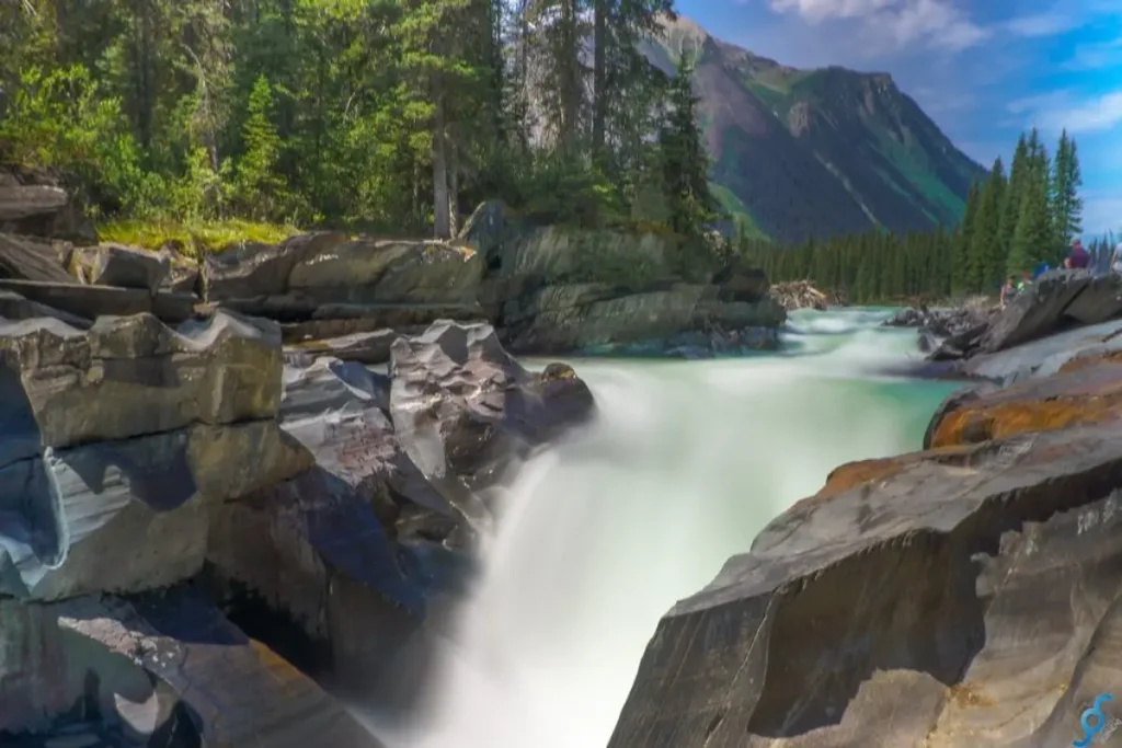 Glacial river rushing through rocky gorge in stop at numa falls kootenay national park